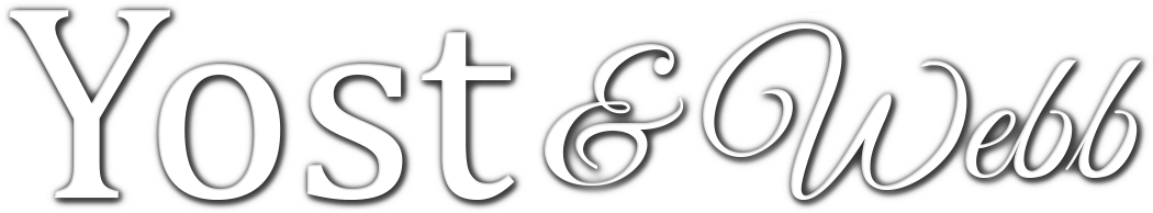 Yost & Webb logo in gray serif lettering with a decorative ampersand