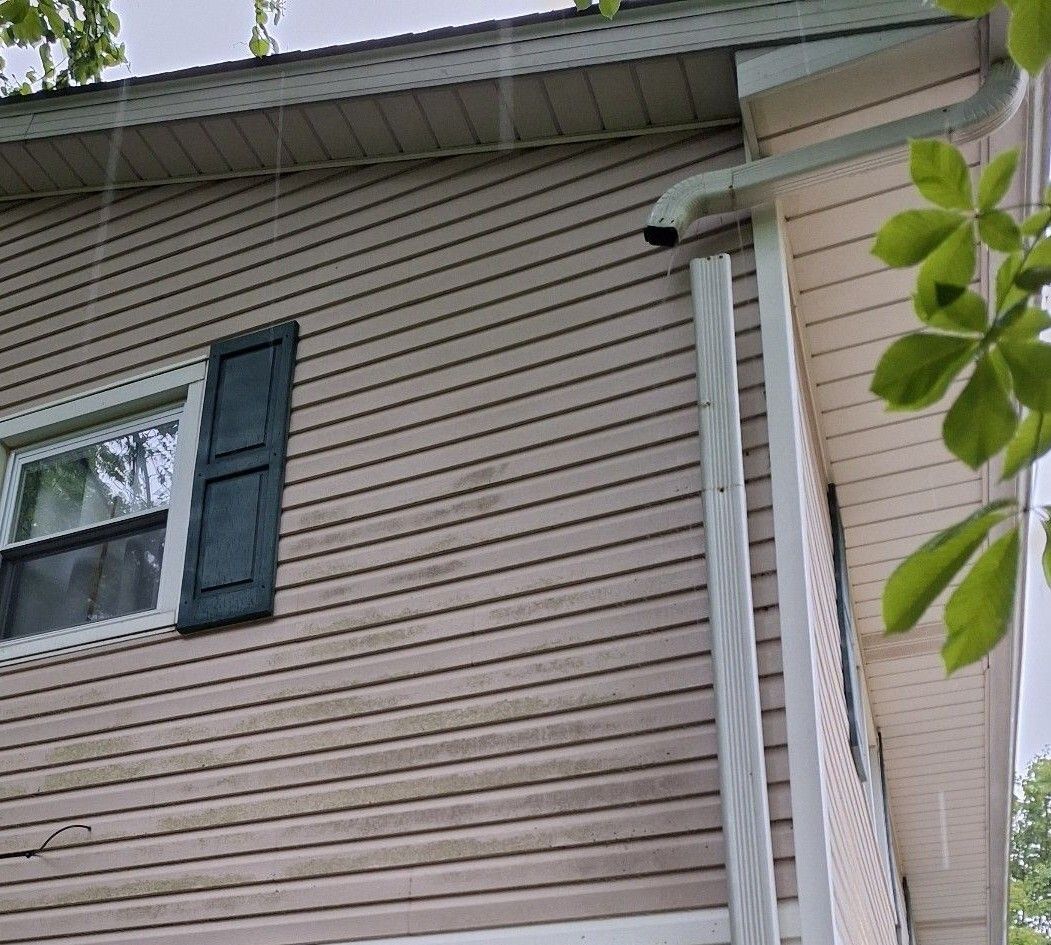 Downspout elbow disconnected from the leader awaiting repair