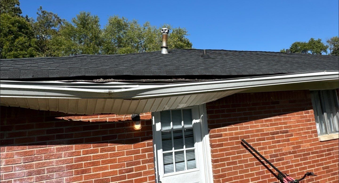 Sagging gutter pulling away from damaged fascia on a brick home