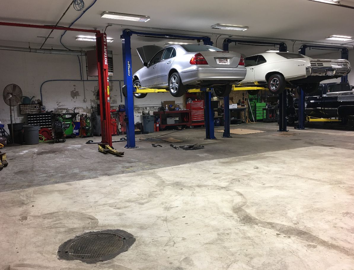 Vehicles in garage for auto repair in Melrose, MA | Certified Automotive Solutions