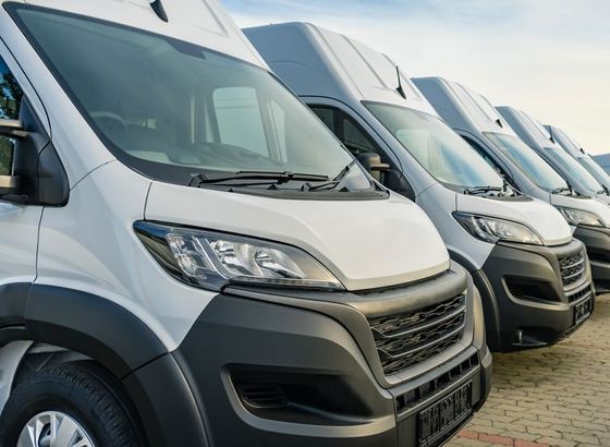Row of white fleet vehicles parked outside | Certified Automotive Solutions
