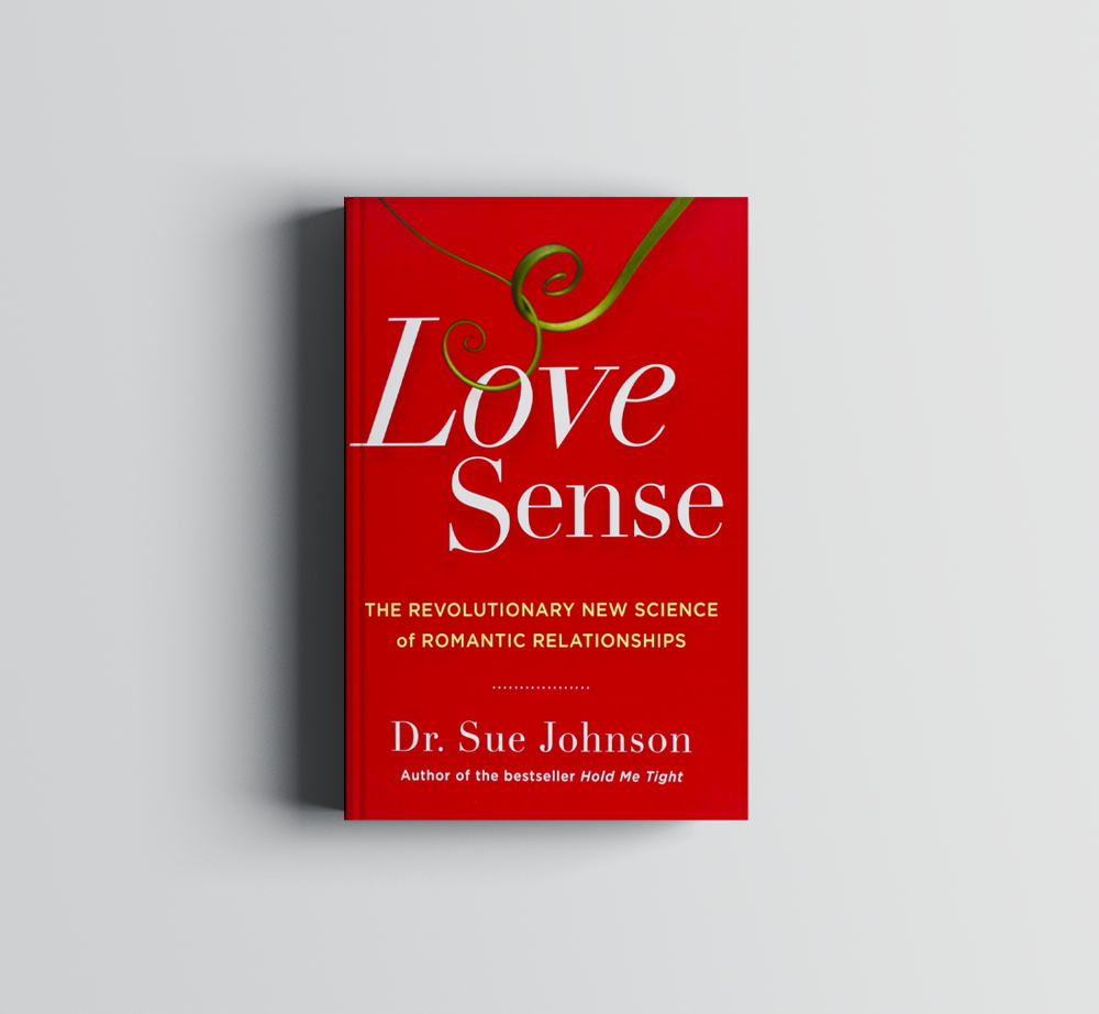 A red book titled Love Sense by Dr. Sue Johnson