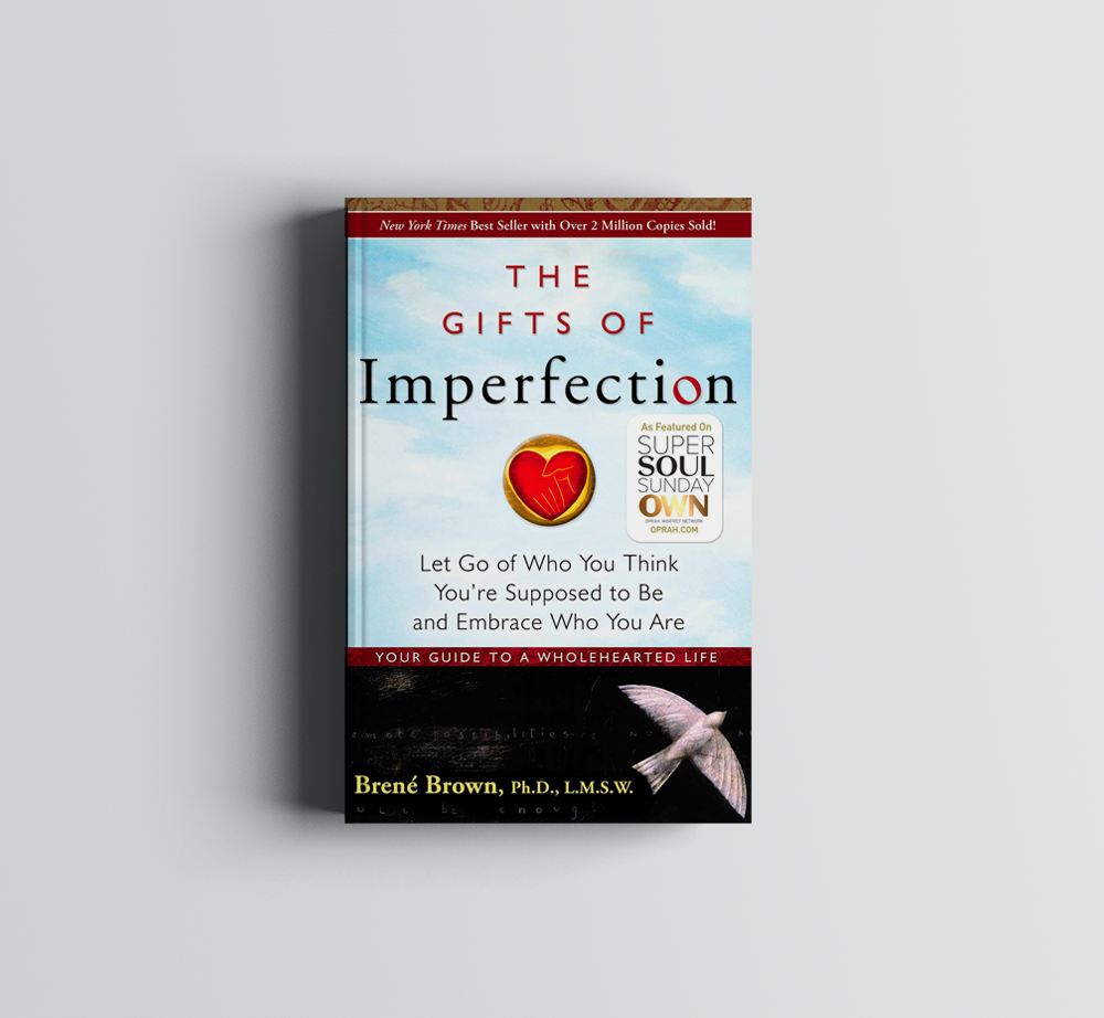 A book titled the gifts of imperfection is sitting on a table.