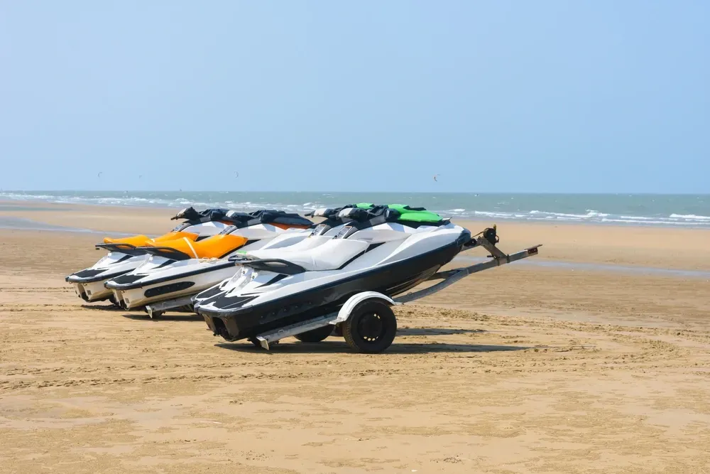 Three jet skis on a sandy beach under a blue sky — Gympie Mini Storage in Gympie, QLD