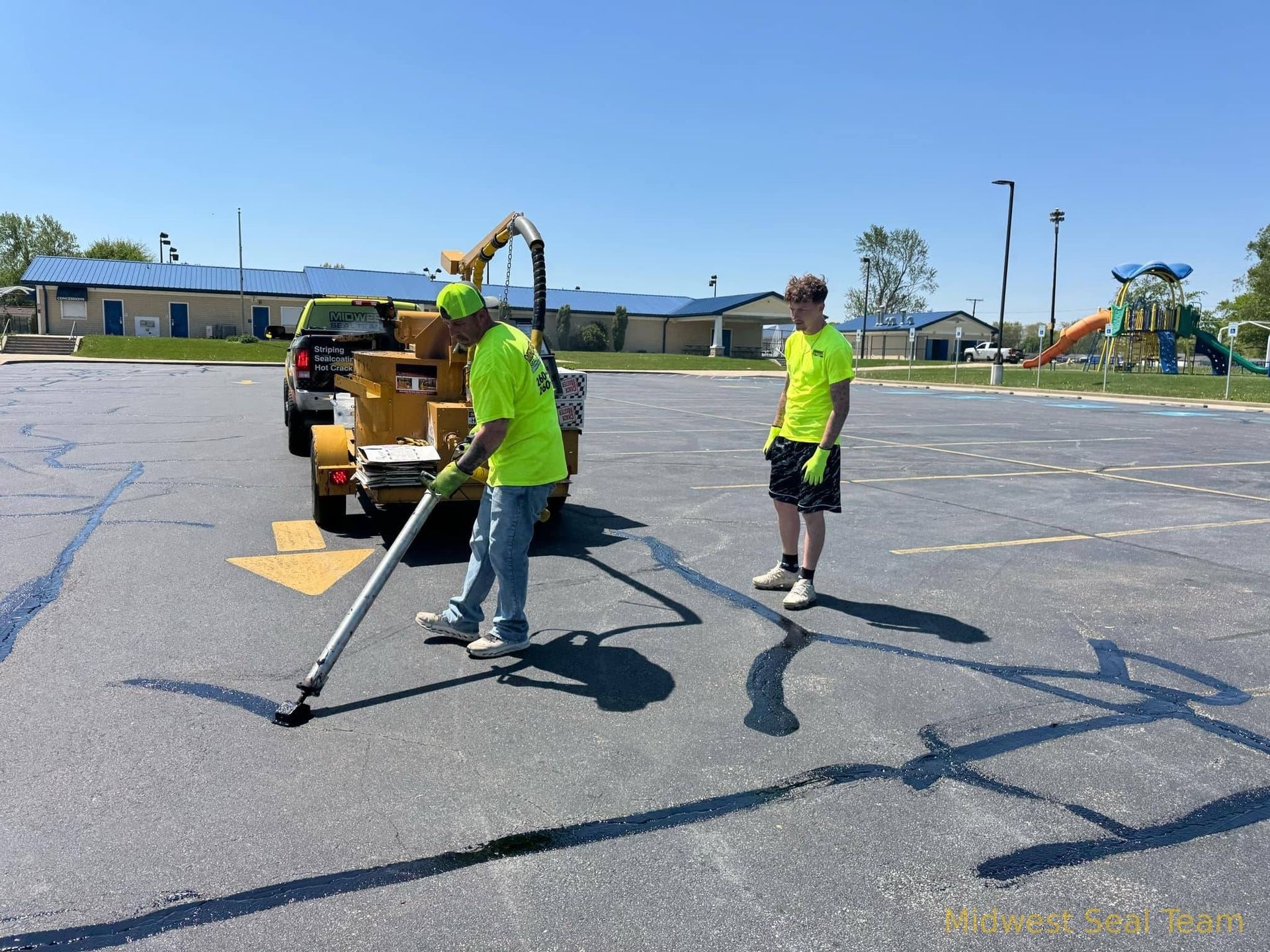 Image of Midwest Seal Team crack filling in a parking lot. You can see the Midwest Seal Team crack filling crew sealing cracks in a parking area here in Auburn, Indiana.