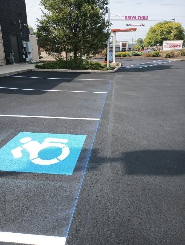 Image showing parking lot painting application process being carried out by Midwest Seal Team in Fort Wayne, IN.