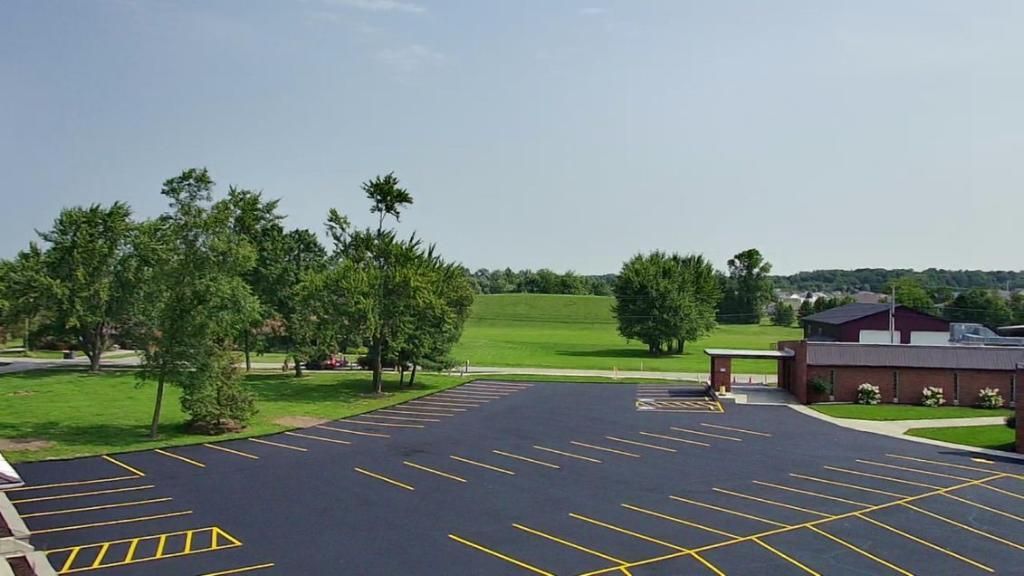 Image showing a demonstration of the precise pavement marking technique employed by the Midwest Seal Team to ensure accuracy and consistency in Fort Wayne, IN.
