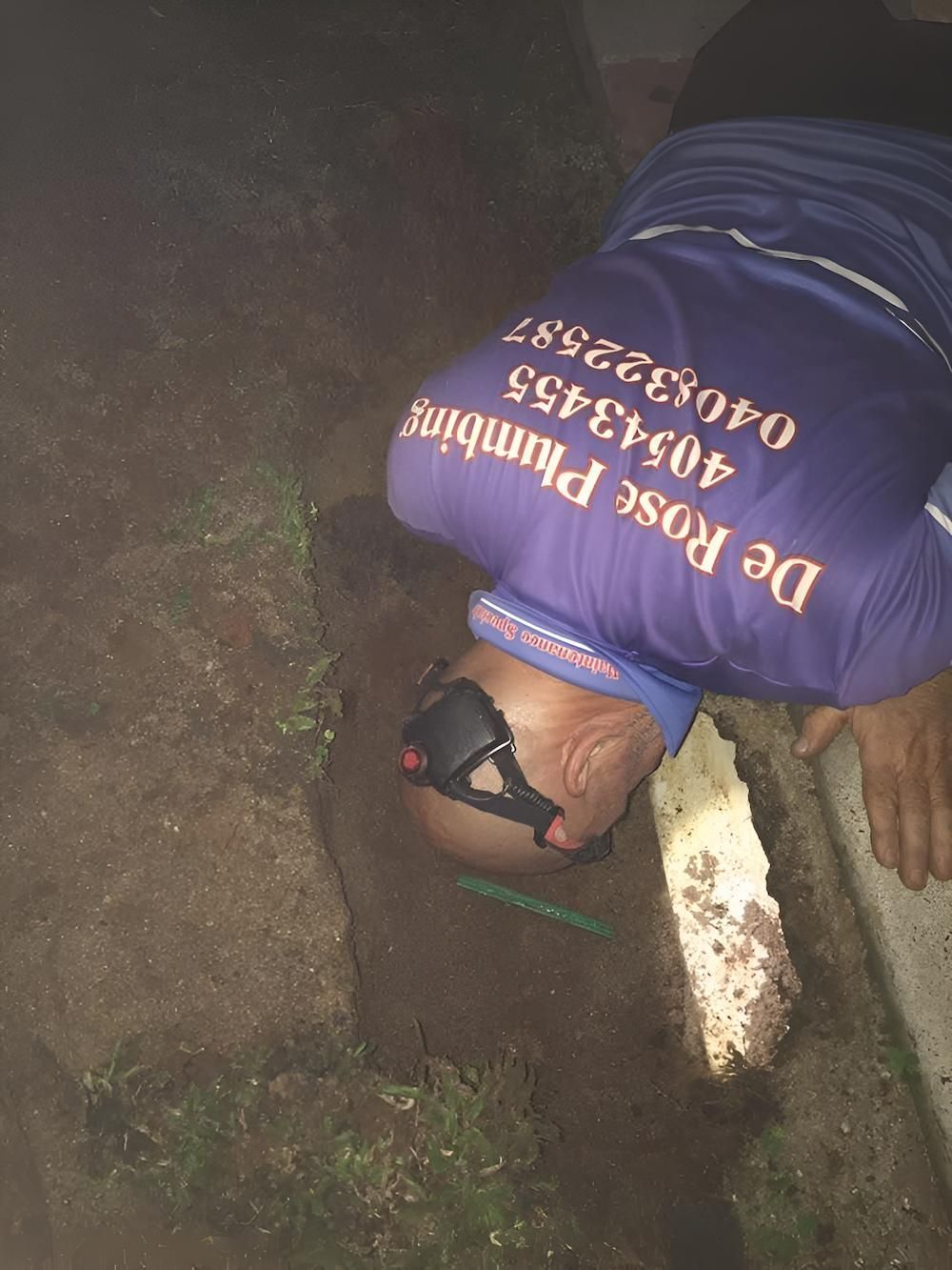 A Man Wearing a Purple Shirt That Says De Rose Plumbing — De Rose Plumbing In Bayview Heights, QLD