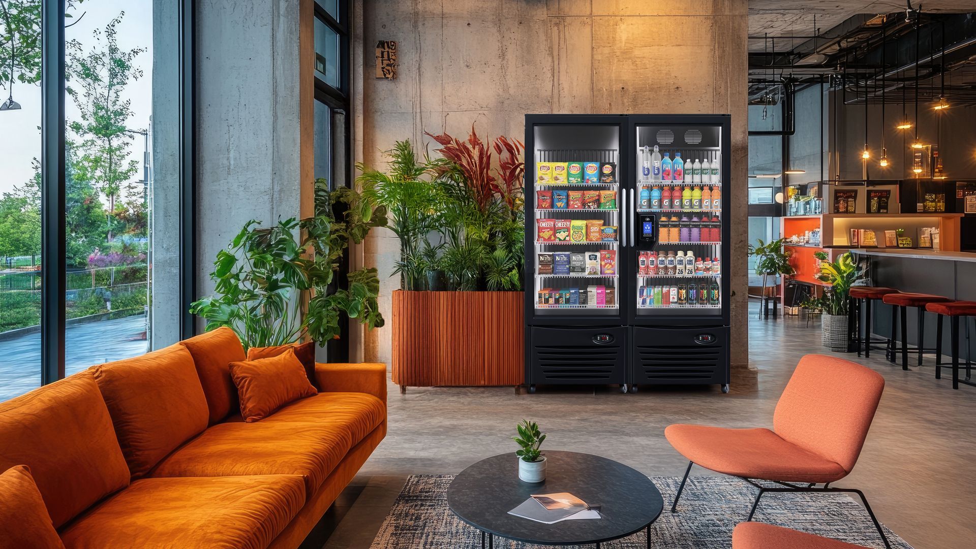 Modern lounge with orange sofa, armchair, coffee table, plants, and lit vending machines by large windows