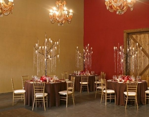 A room with tables and chairs set up for a wedding reception