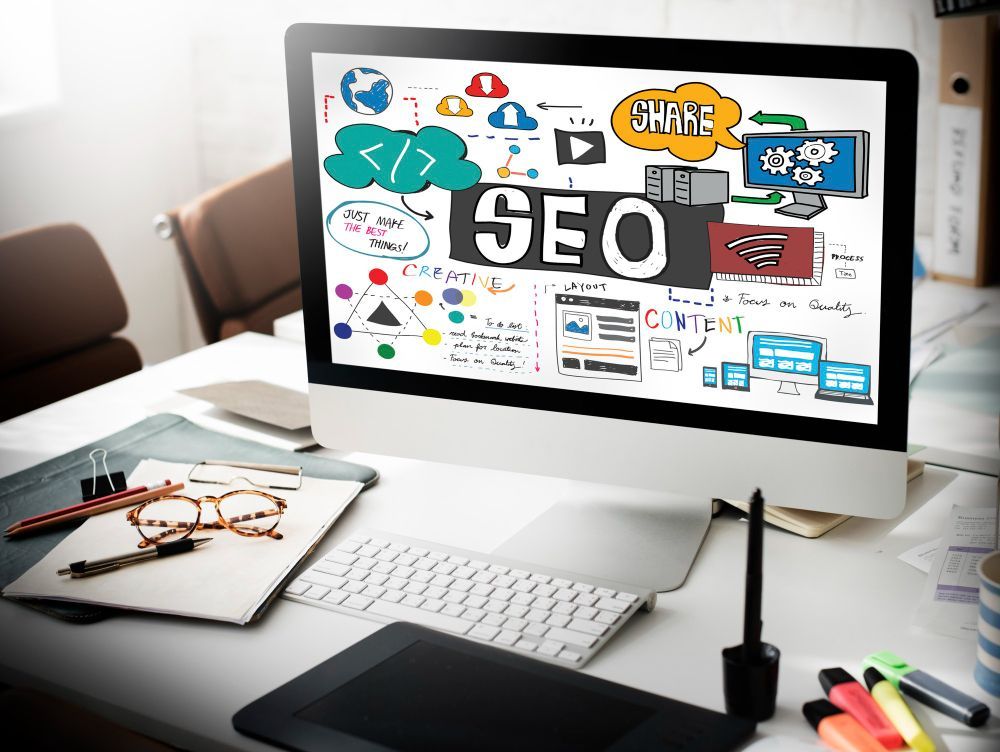 A computer monitor with the word seo on it is sitting on a desk.