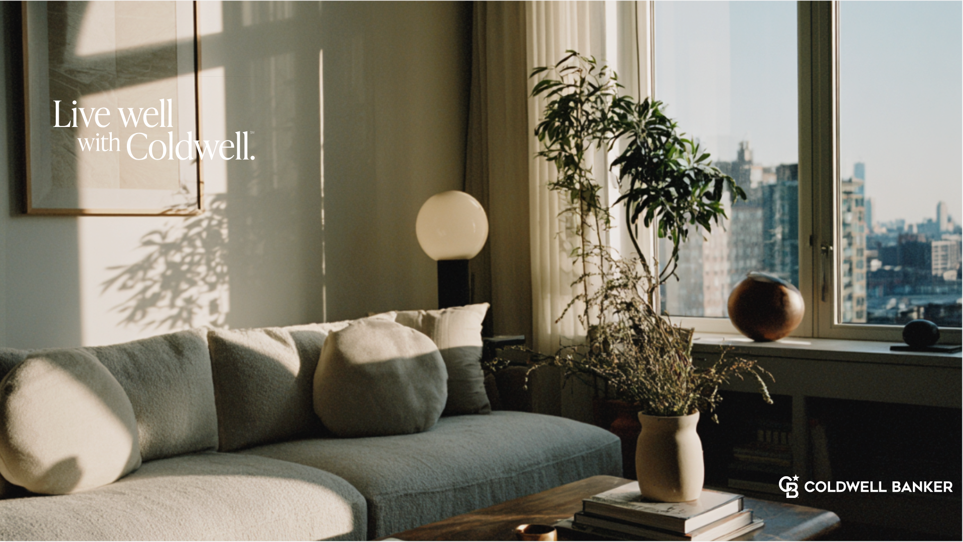 Cozy living room with sunlight, sofa, and city view. Text reads