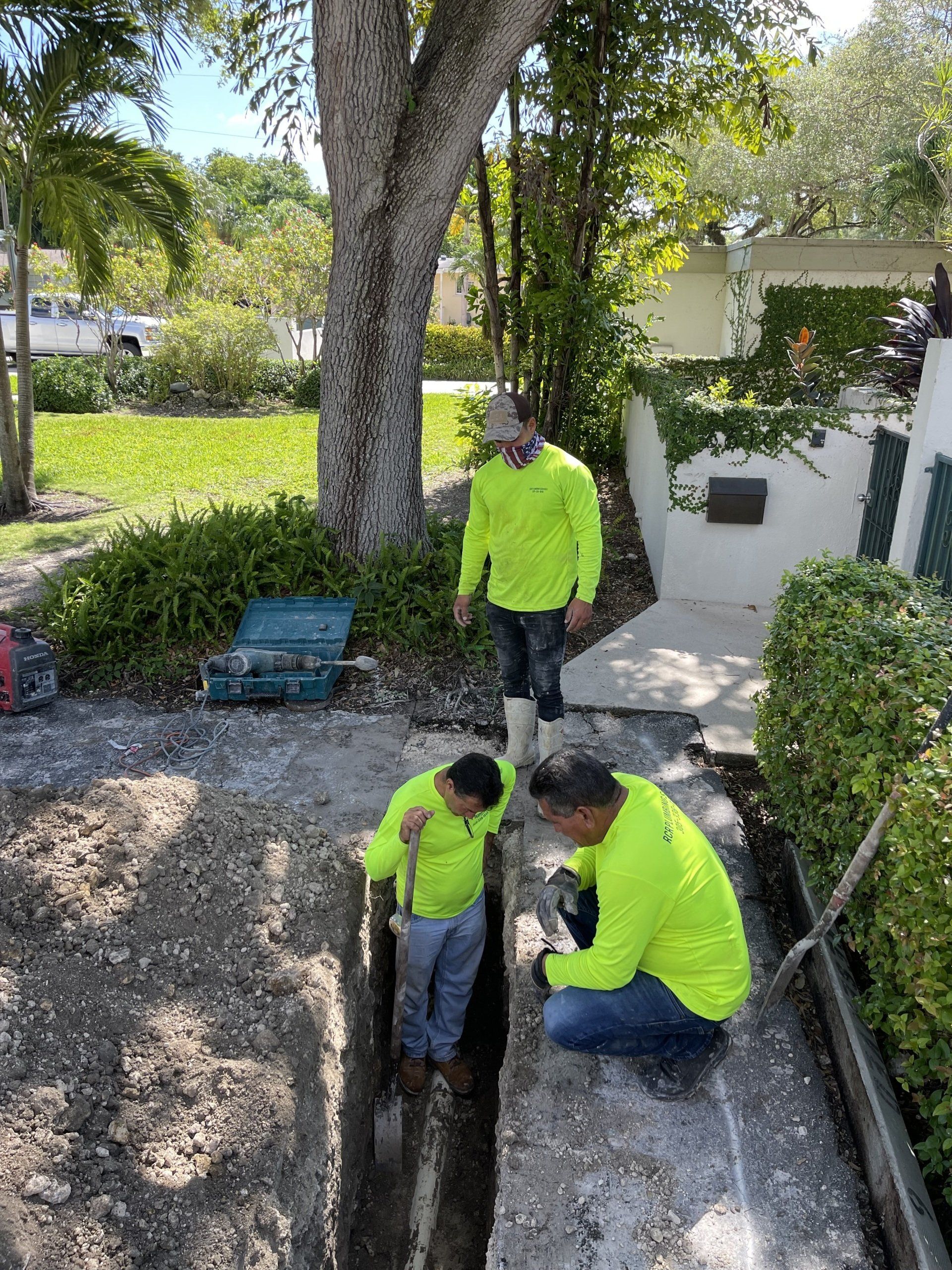 Plumbers digging trench