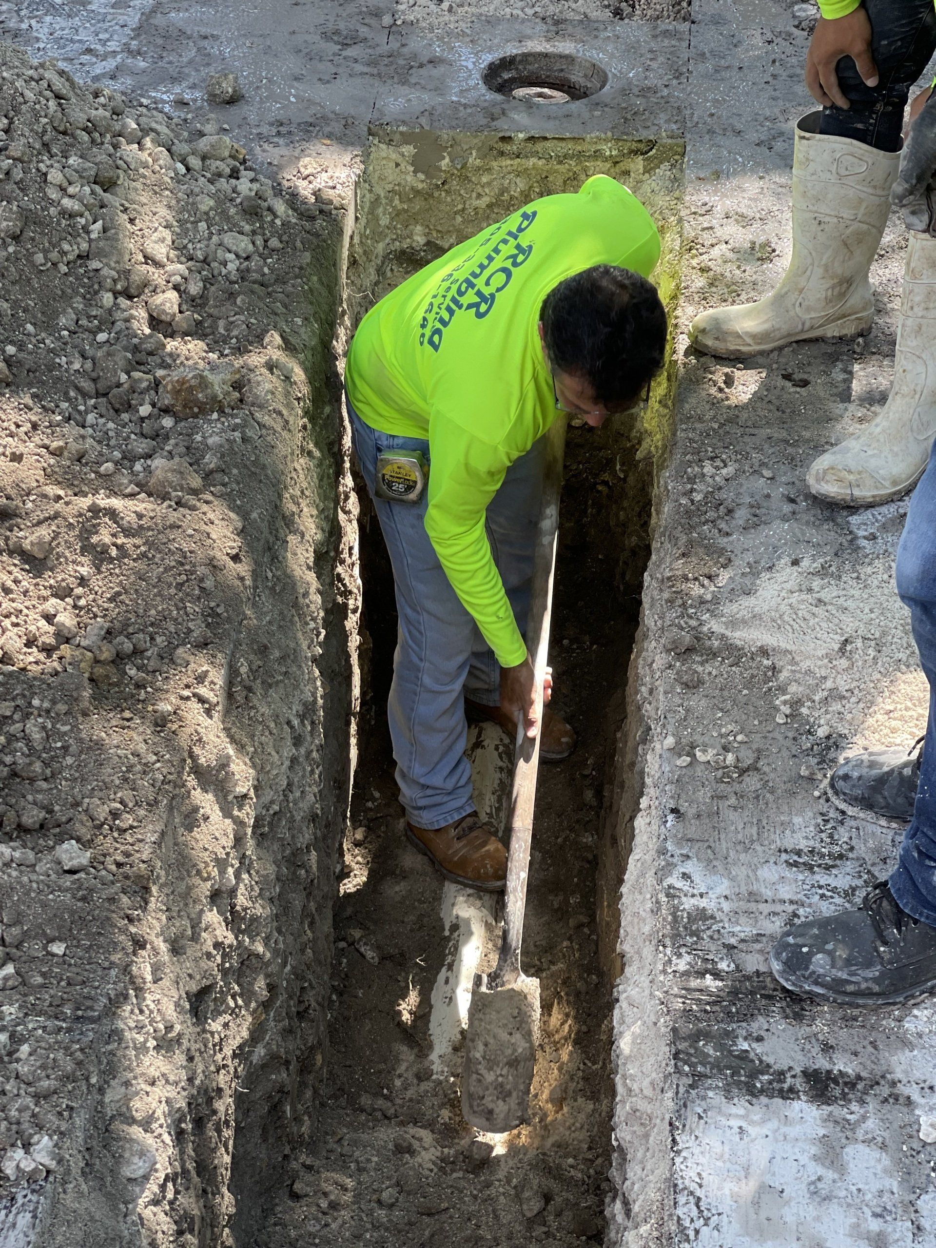 Plumber digging a trench