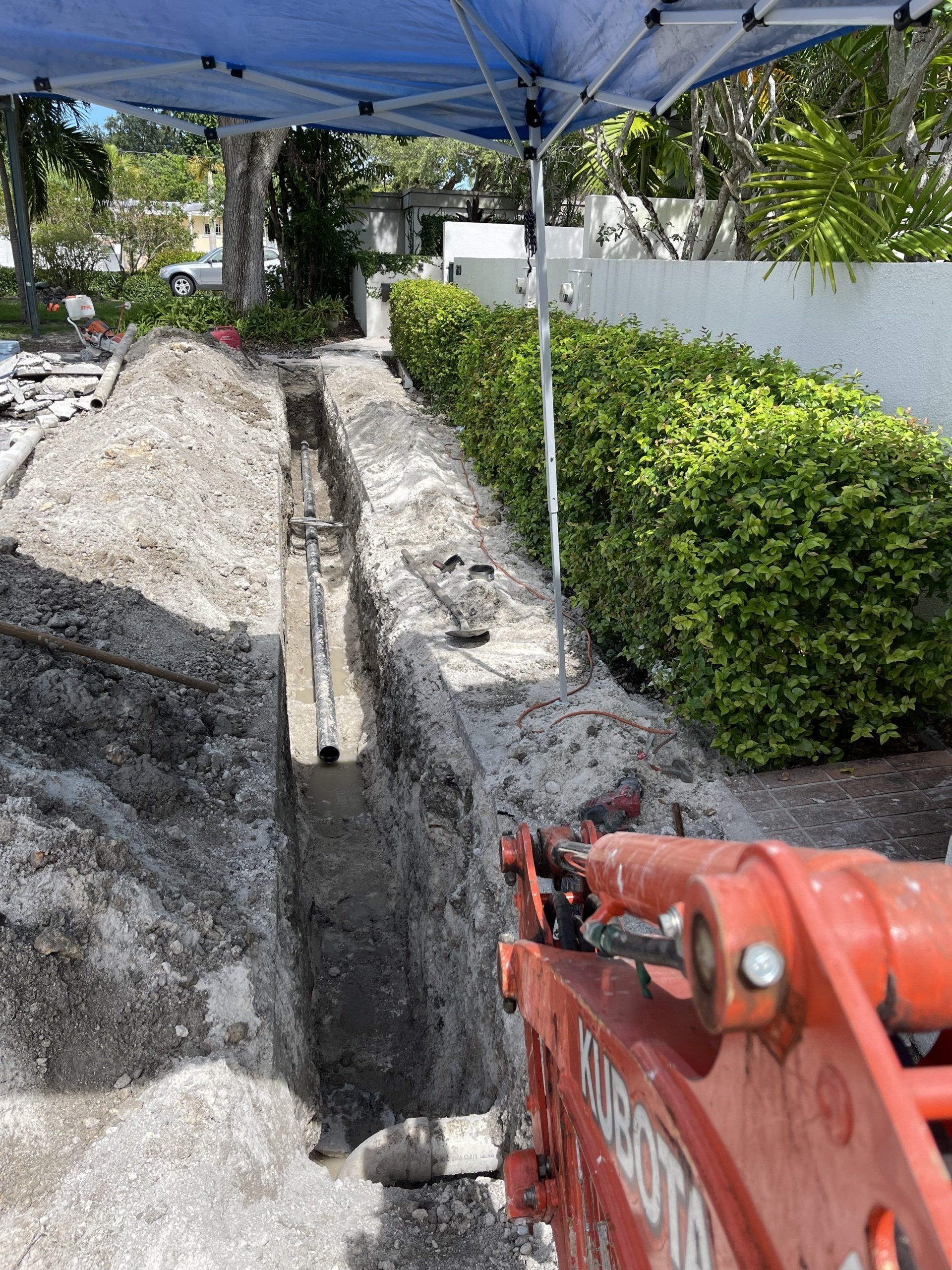Plumbers digging trench