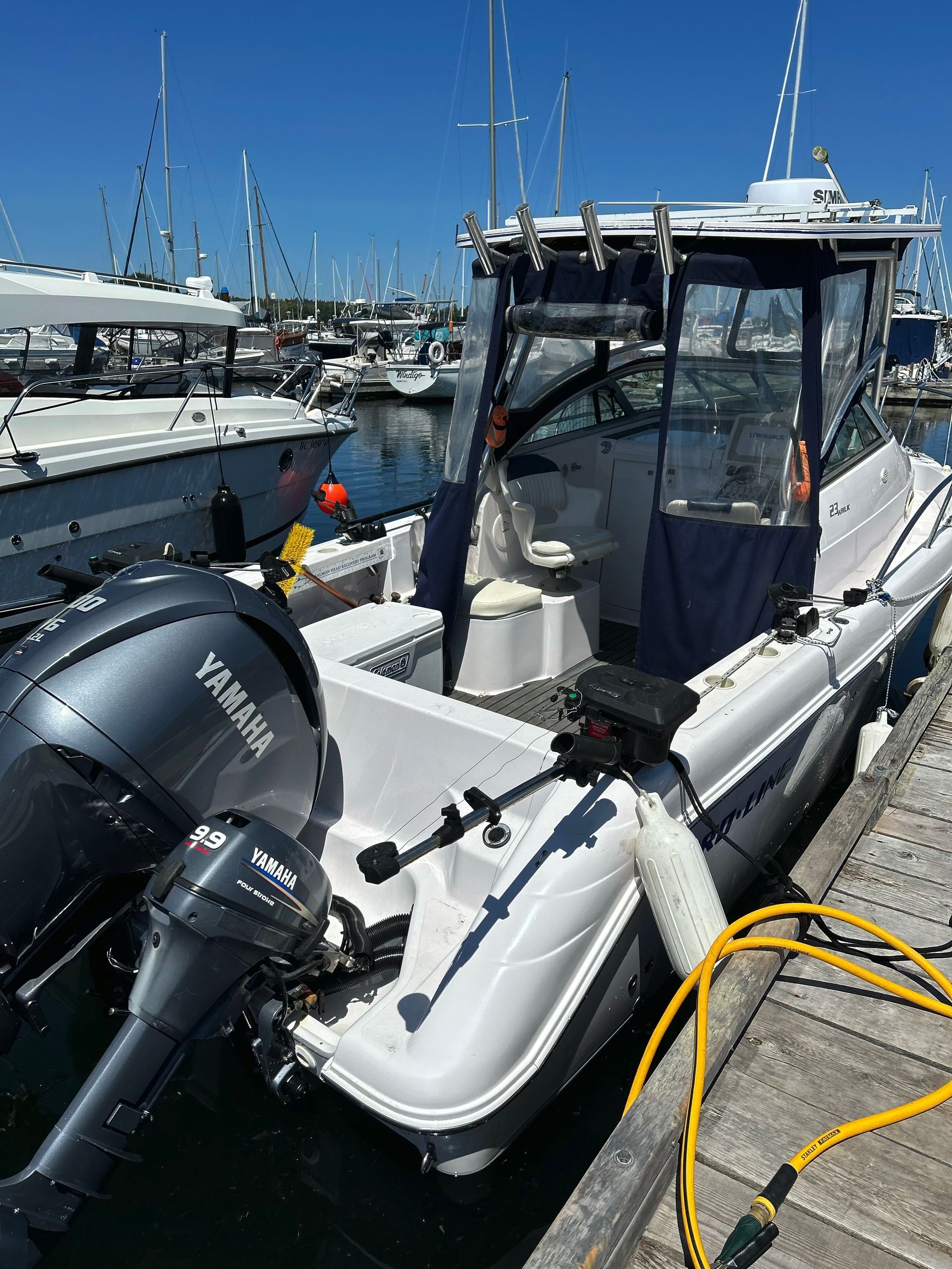 A boat with a yamaha engine is docked at a dock.