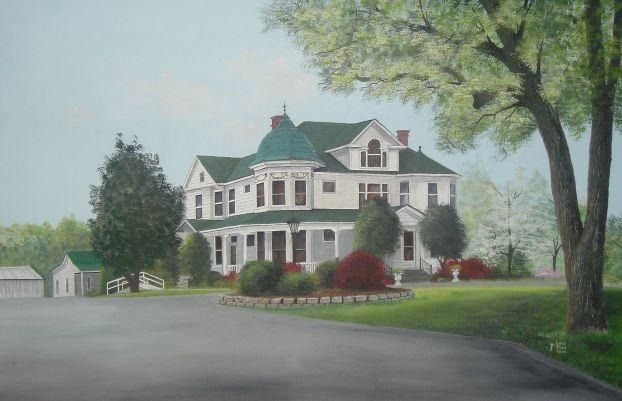 White Victorian house with green roof and landscaping, driveway curving towards it under a cloudy sky.