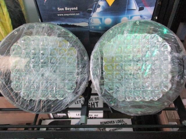 A Pair Of Lights Are Wrapped In Plastic And Sitting On A Shelf — Goulburn Automotive Centre In Goulburn, NSW