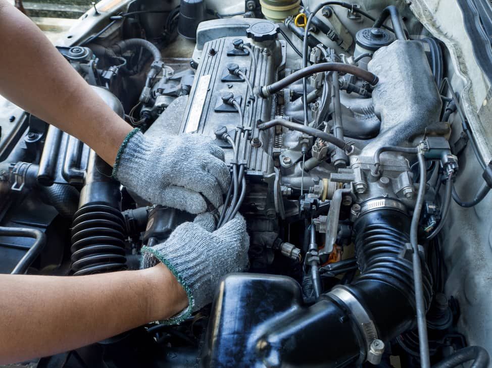 A Person Is Working On The Engine Of A Car — Goulburn Automotive Centre In Goulburn, NSW