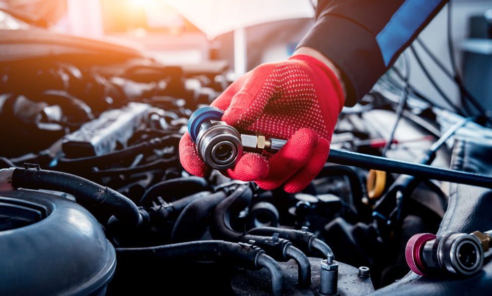 A Mechanic Is Working On The Engine Of A Car — Goulburn Automotive Centre In Goulburn, NSW