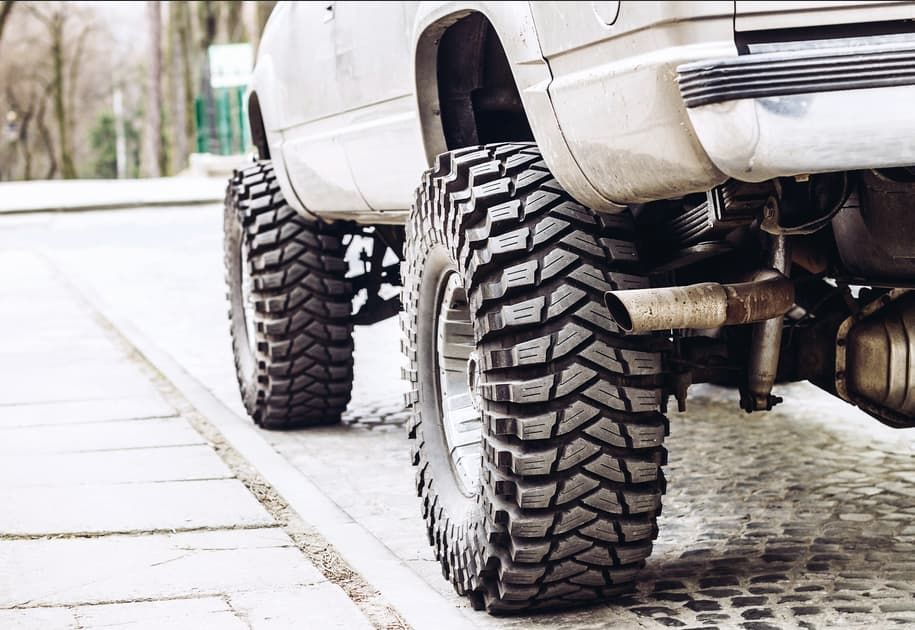 A White Truck With Big Tires Is Parked On The Side Of The Road — Goulburn Automotive Centre In Goulburn, NSW
