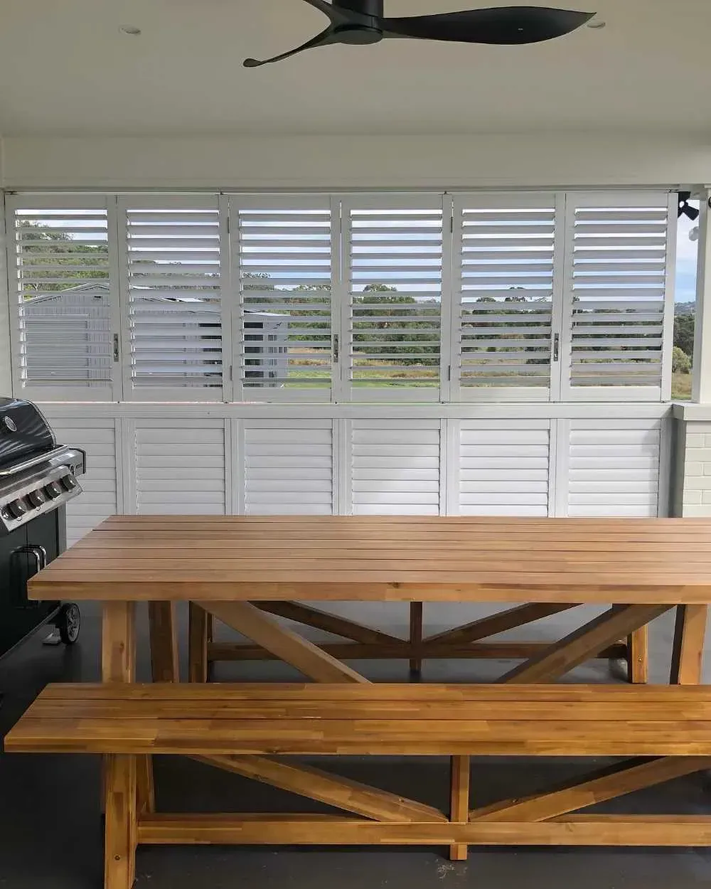 Wooden Dining Table and Bench on A Covered Patio — Tamworth Blinds & Awnings in Tamworth, NSW