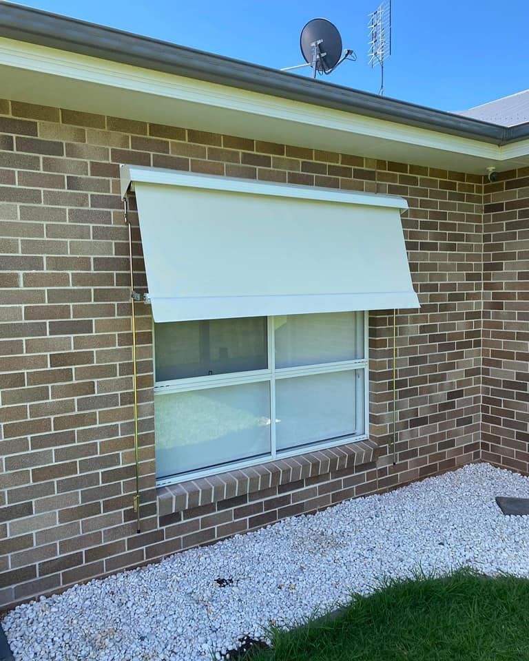 Brick House Exterior with A White Window Awning — Tamworth Blinds & Awnings in Quirindi, NSW