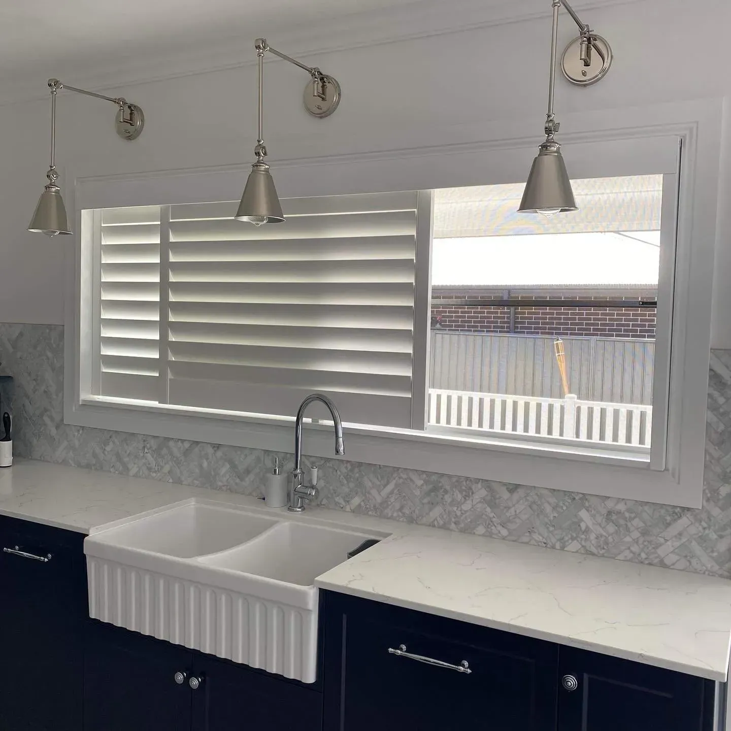 Modern Kitchen with White Double Sink, Navy Cabinets and Marble Counters — Tamworth Blinds & Awnings in Tamworth, NSW