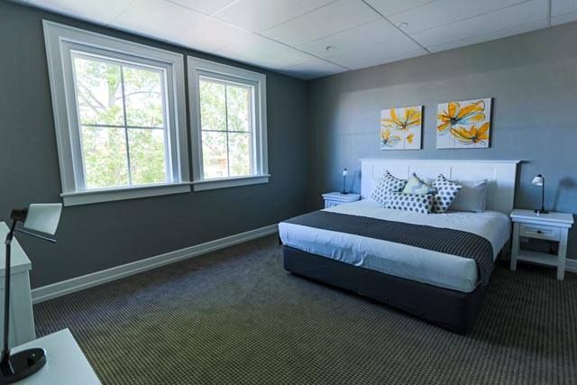 Modern Bedroom with Blue Walls and Large Windows — Tamworth Blinds & Awnings in Tamworth, NSW