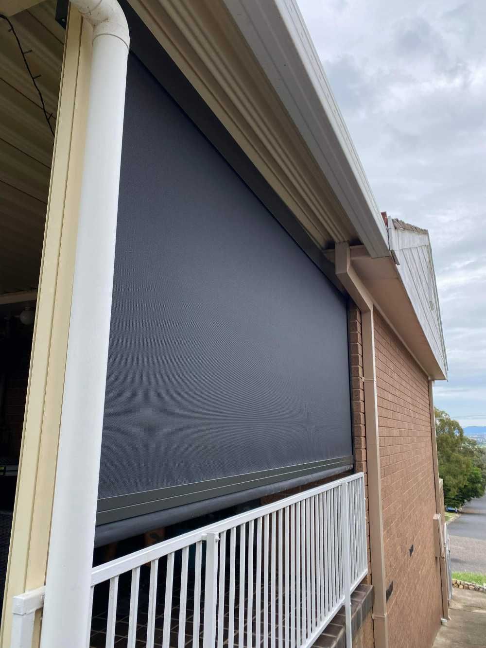 Outdoor Balcony with A Rolled-Down Dark Roller Shade — Tamworth Blinds & Awnings in Tamworth, NSW