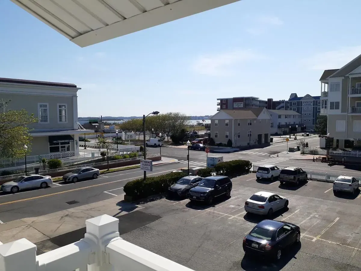 A view of a parking lot with cars parked on the side of the road