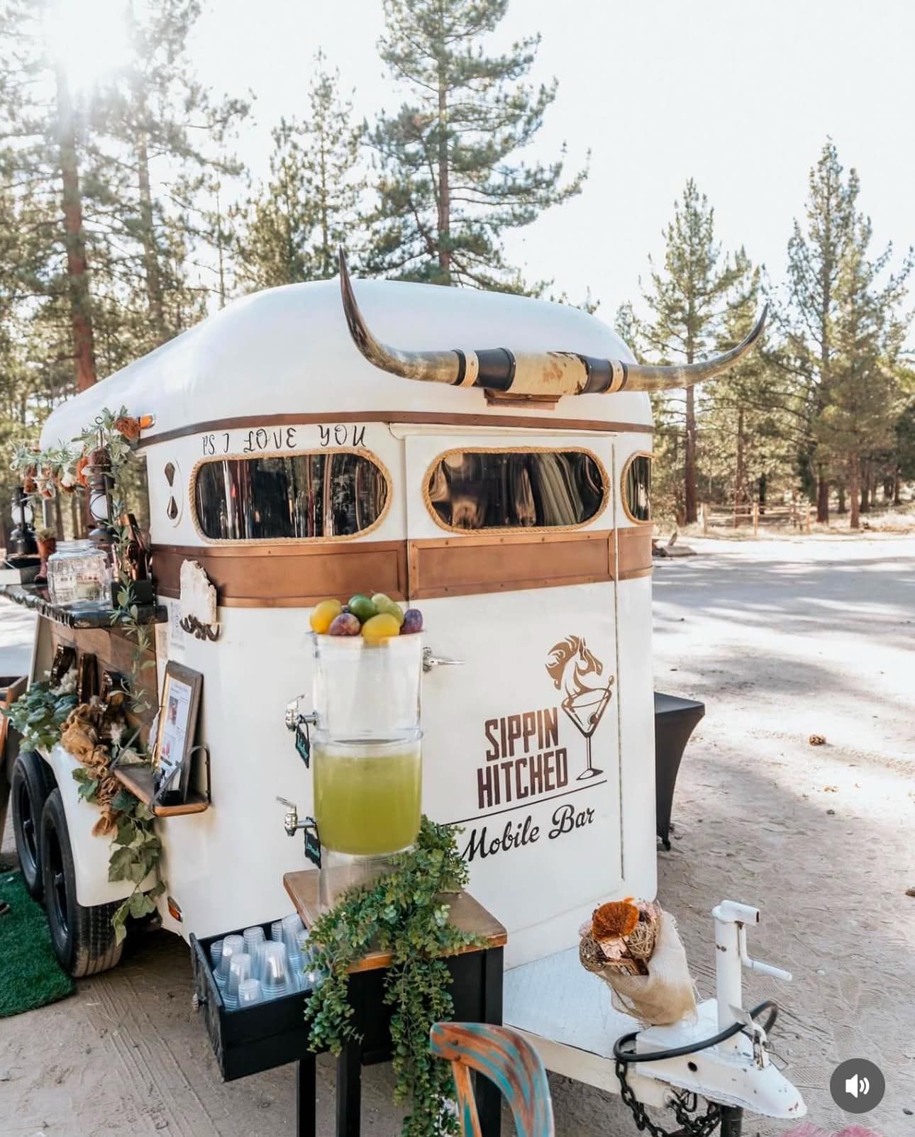 A trailer with a bar on it is parked on the side of the road.