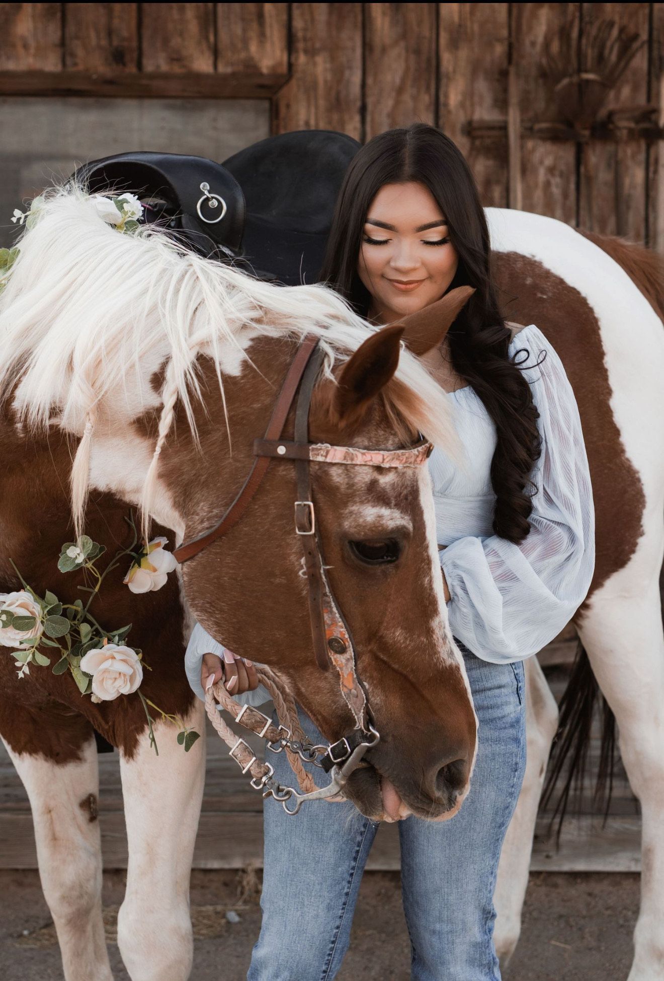 A little girl is riding a pony in a dirt field.