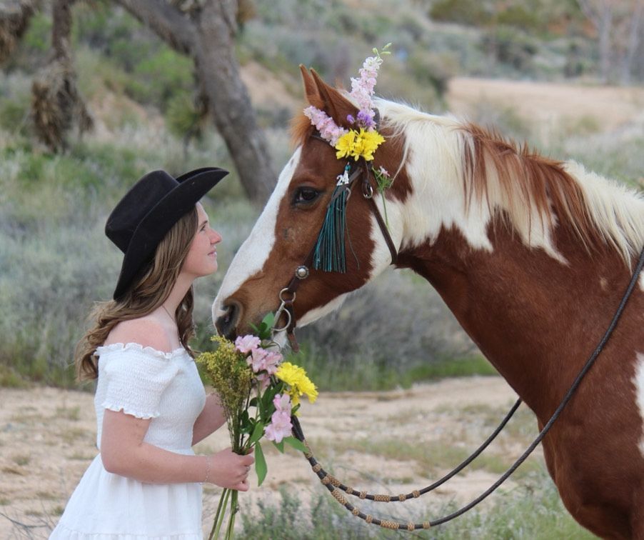 A little girl is riding a pony in a dirt field.