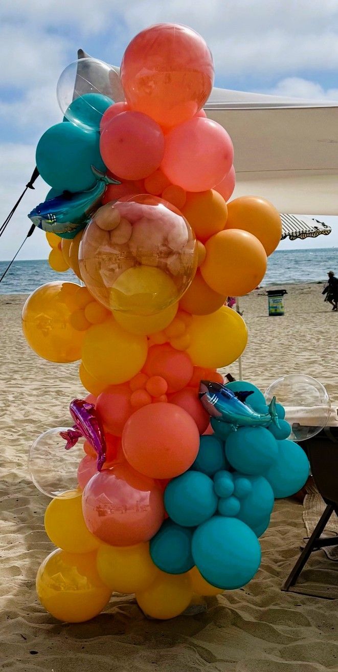 Ocean, sea, beach themes have been popular with orange, coral and teal colors for 2026 beach birthday parties. Los angeles