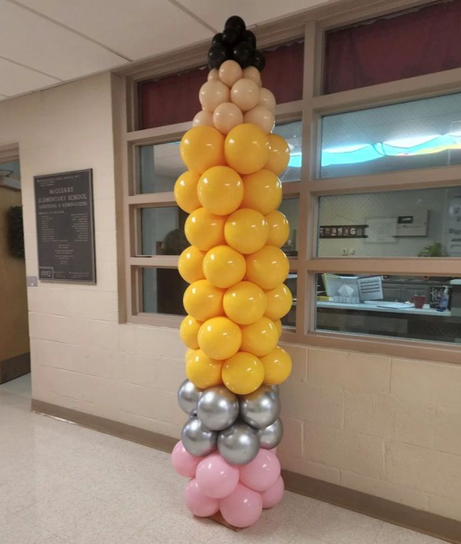Birthday helium balloon filled bouquet with large foil numbers.