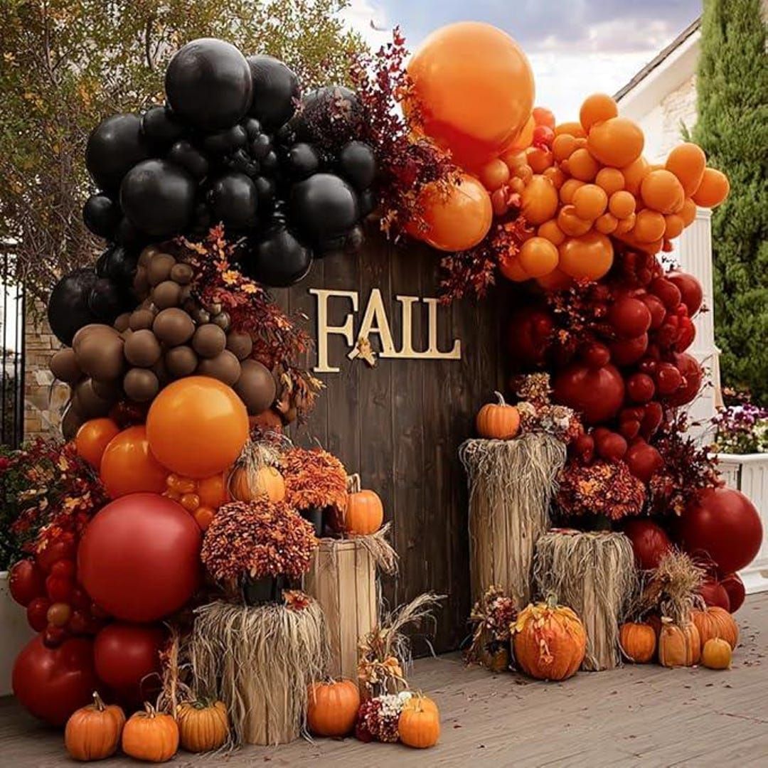 Fall balloon arch in burnt orange terracotta and cream framing a Los Angeles home entry — fall balloon delivery Los Angeles