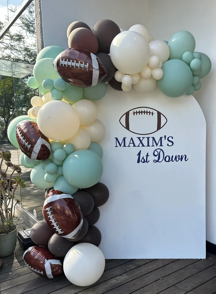 Organic Balloon Garland on pot wall backdrop for pictures outdoors. Football Theme balloons. 