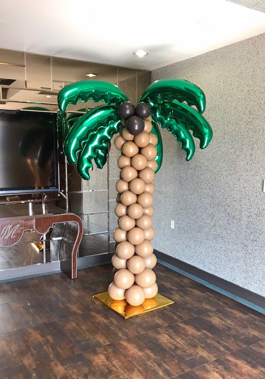 Balloon palm tree with green fronds, brown trunk, and black coconuts, on a gold base.