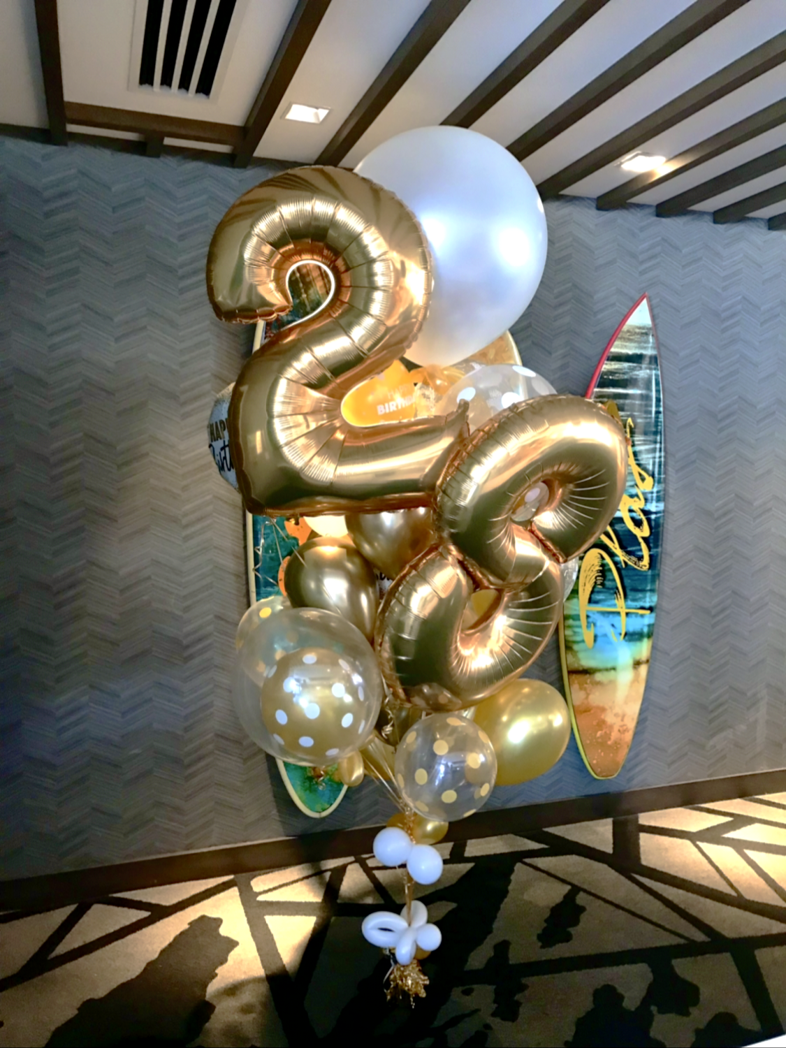 Birthday helium balloon filled bouquet with large foil numbers.