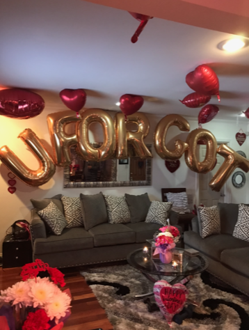 Living room decorated with gold letter balloons