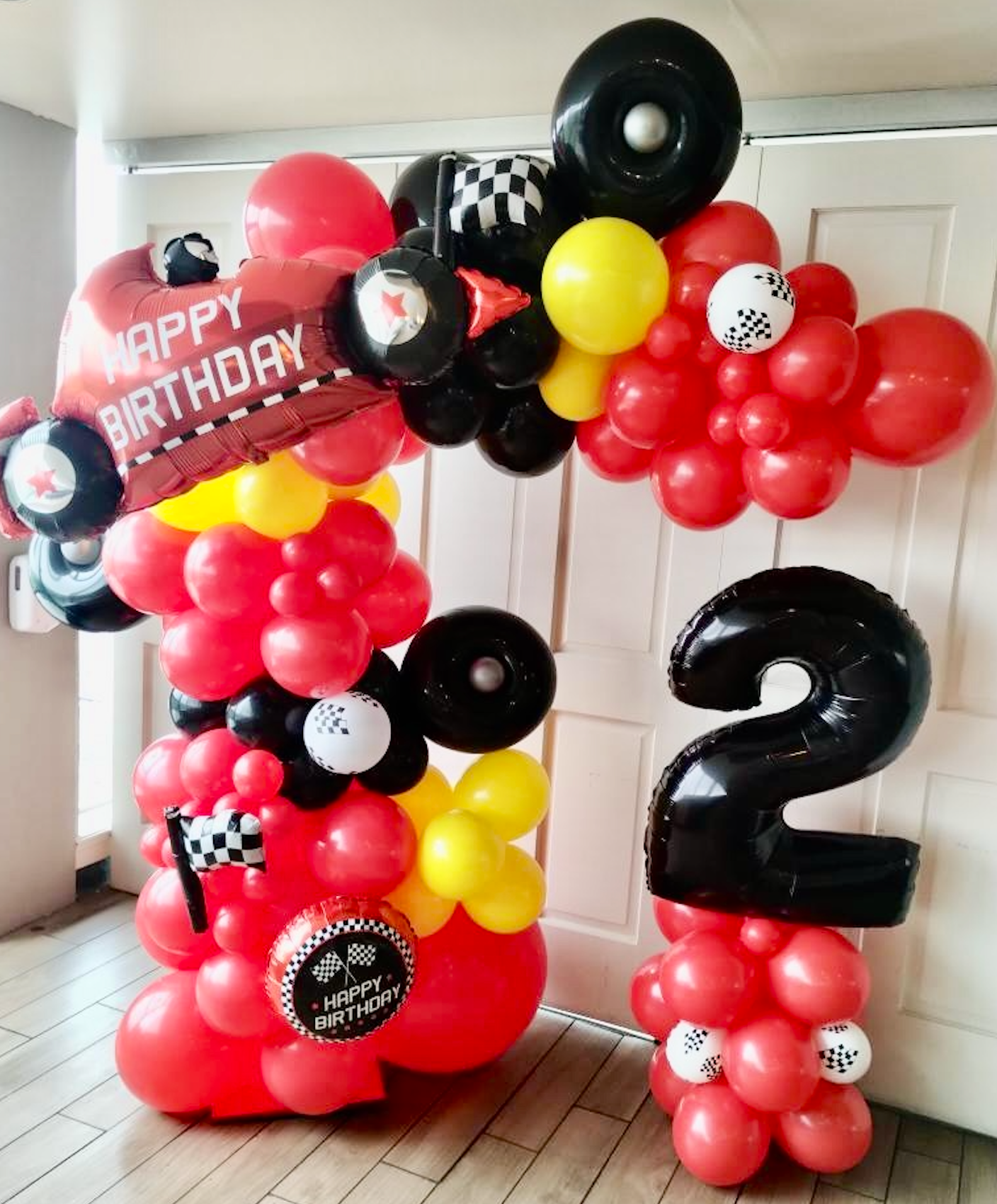 Helium filled red and purple balloons cars birthday theme