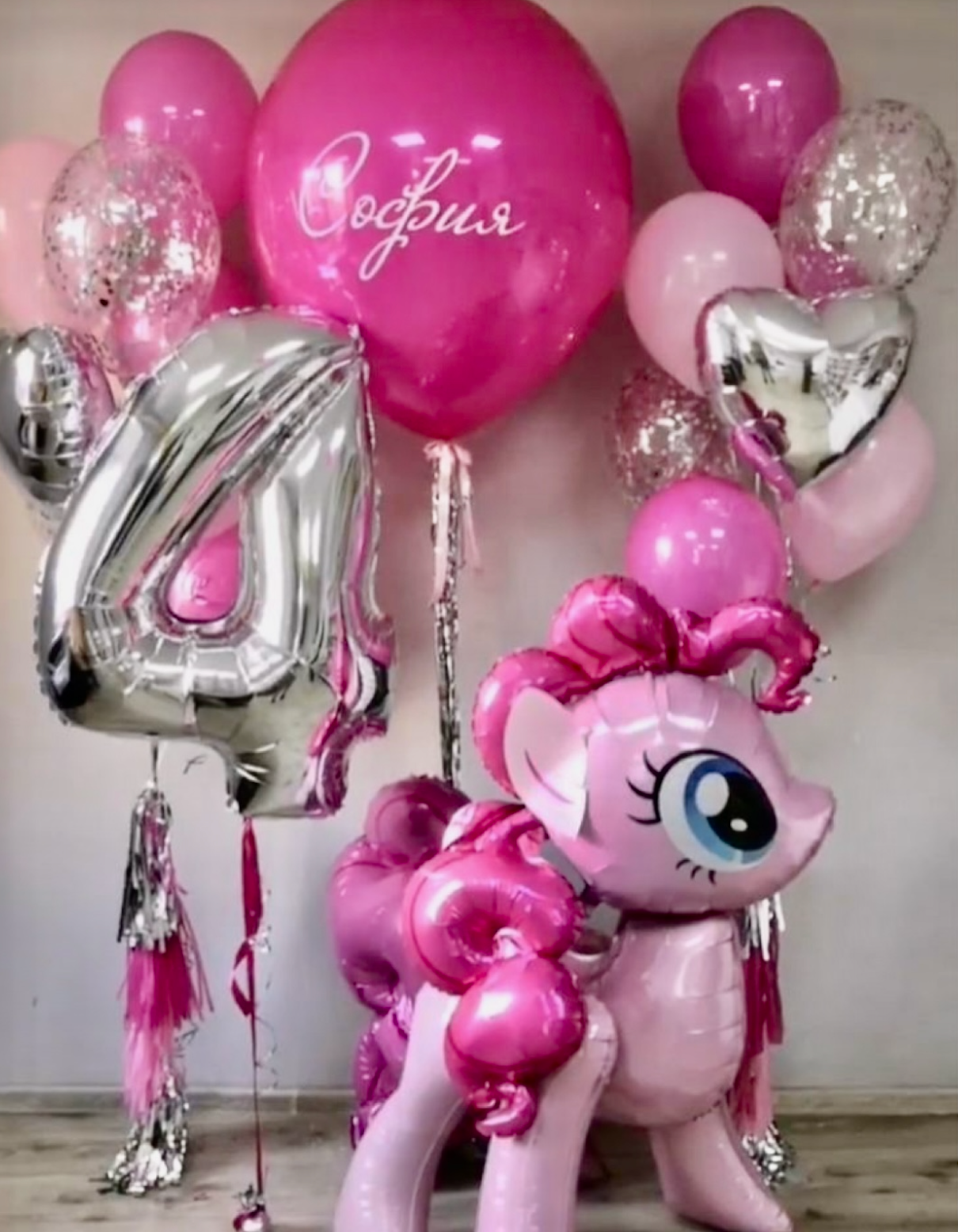 Pink balloon arrangement for a birthday, including a pony character