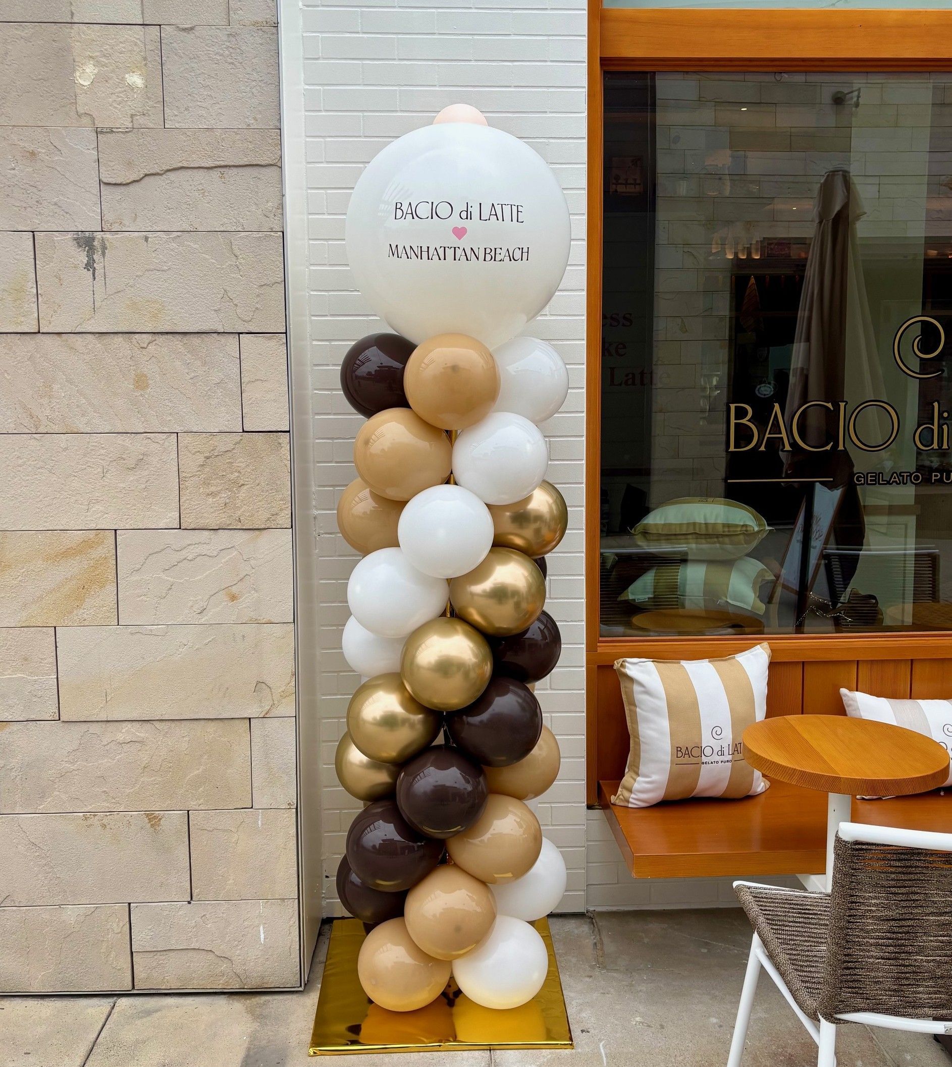 Custom branded balloon column in brand colors with a printed Bacio di Latte logo topper at their Manhattan Beach grand opening