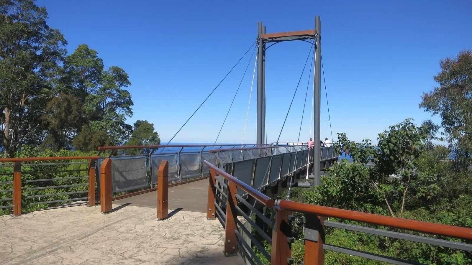 A Brown Bridge Is Looking out To the Sea Surrounded by Trees and Bush — Ground Control Property Maintenance In North Boambee Valley, NSW