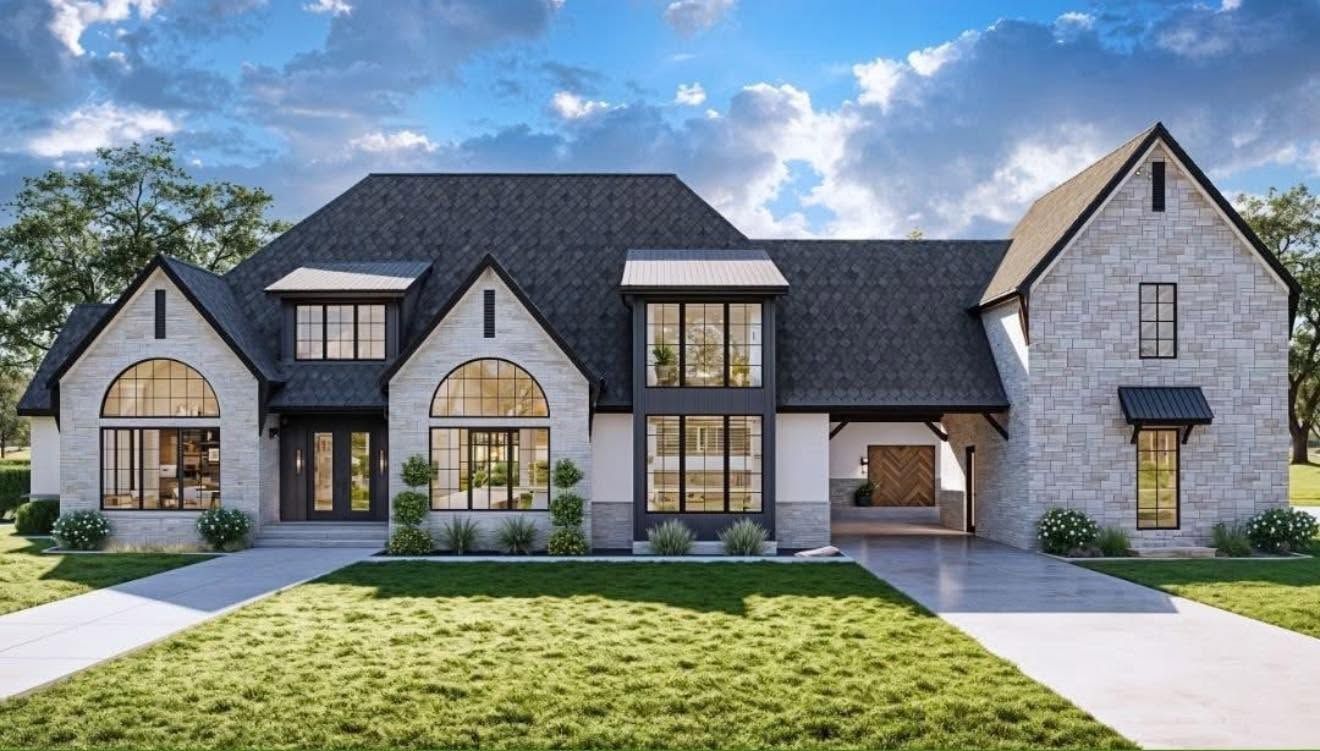 Large modern stone-and-brick house with dark roof, arched windows, and a manicured front lawn