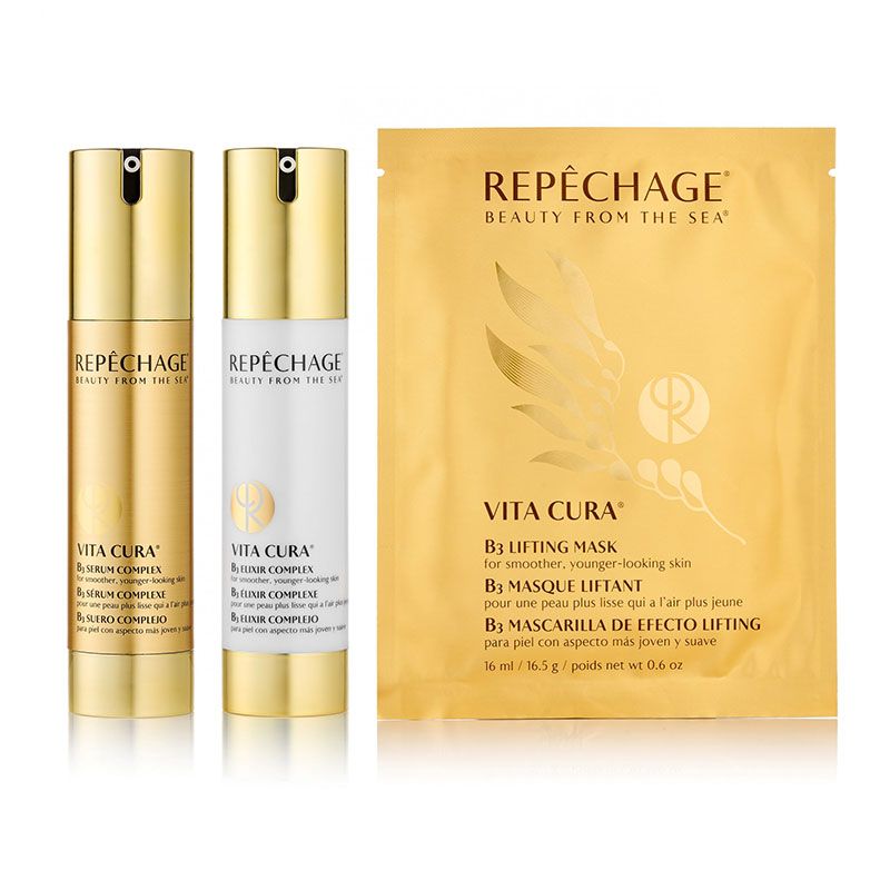 Two gold and white skincare bottles and a gold sachet of Repechage Vita Cura products.