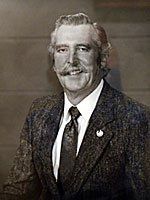 A black and white photo of a man in a suit and tie.
