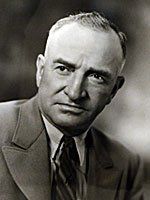 A black and white photo of a man in a suit and tie.