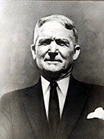 A black and white photo of a man in a suit and tie.